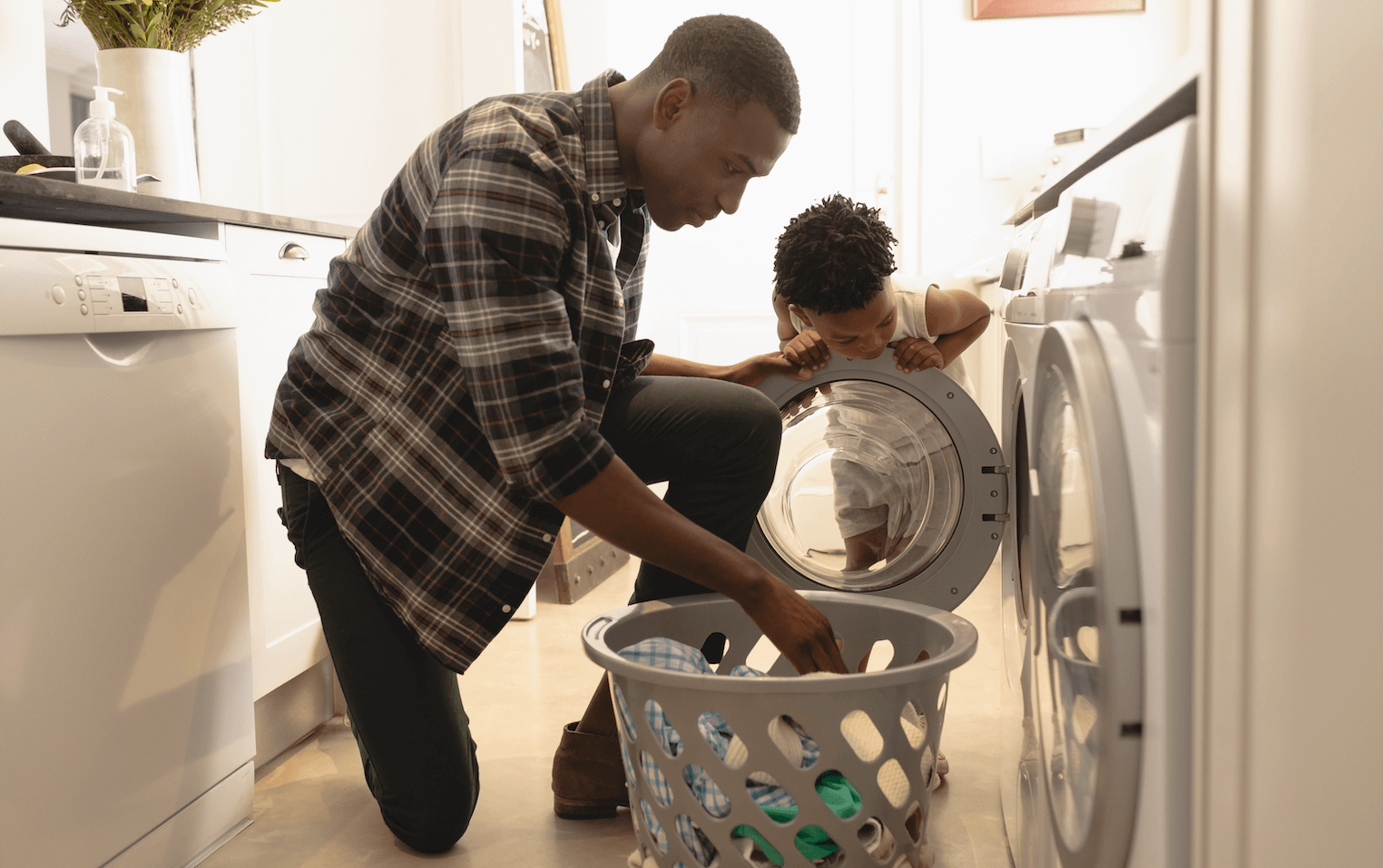 Father and Son unload a dryer together