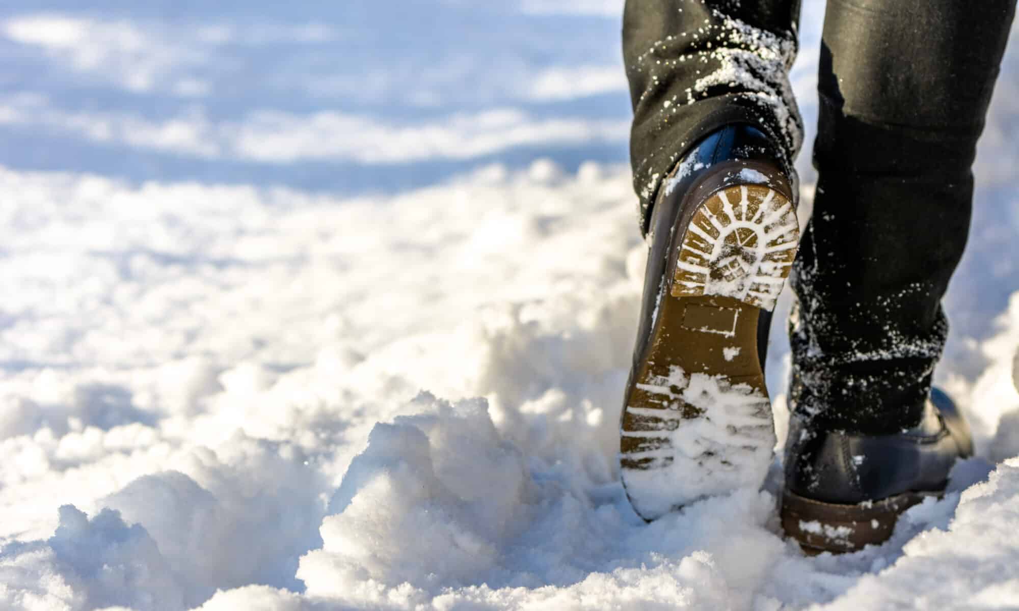 Woman walking in snow boots and jeans on legs, women's winter shoes