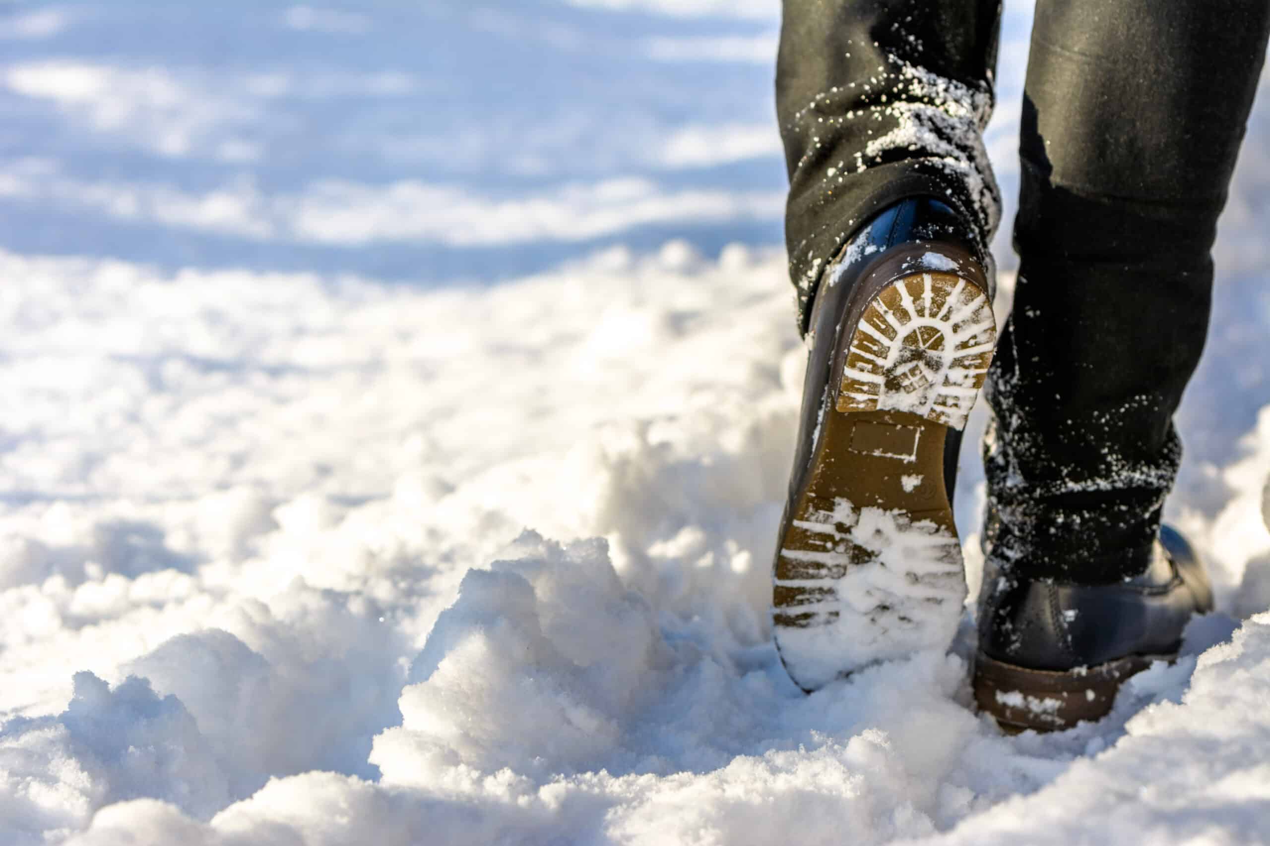 Woman walking in snow boots and jeans on legs, women's winter shoes