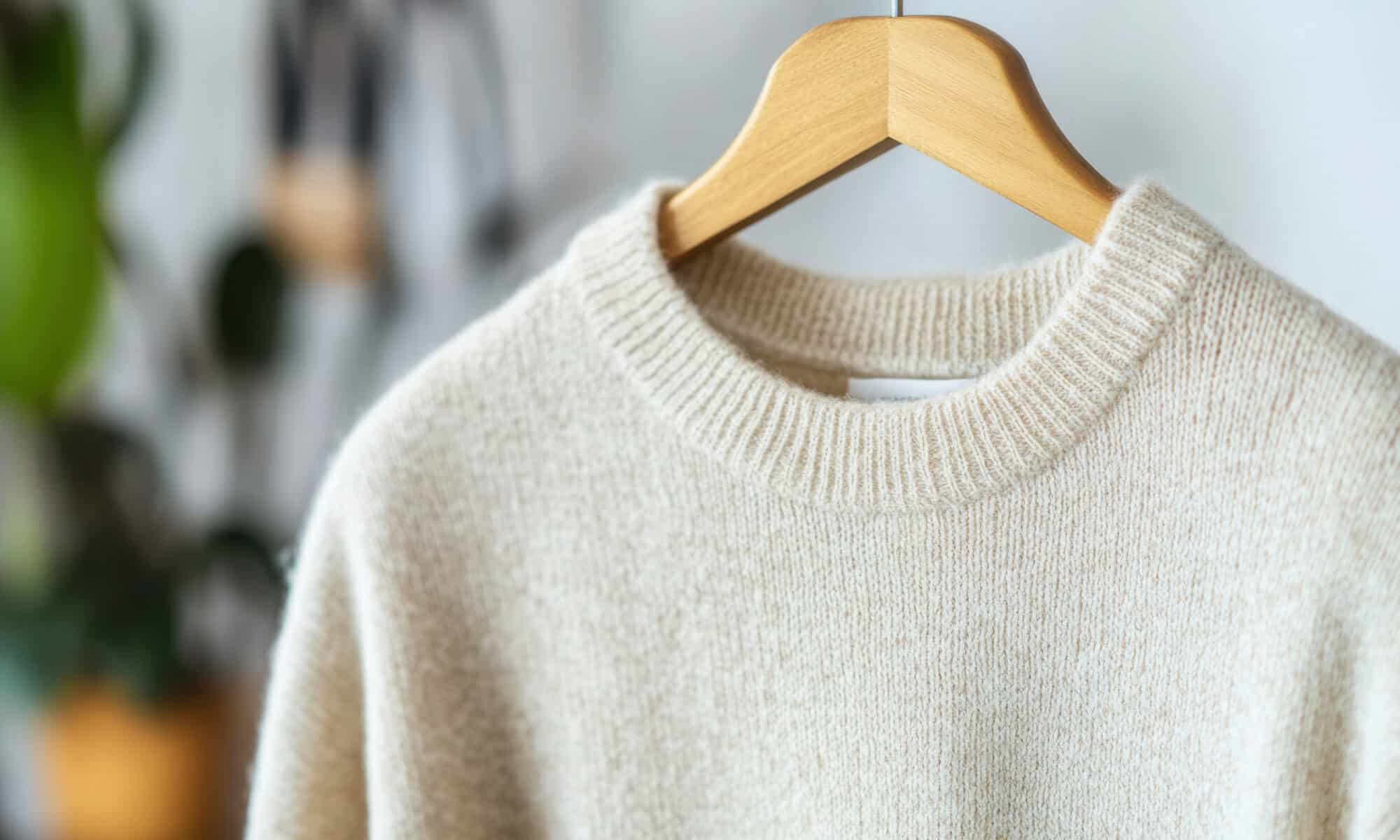 Close up of soft cashmere sweater on hanger for cozy fashion design